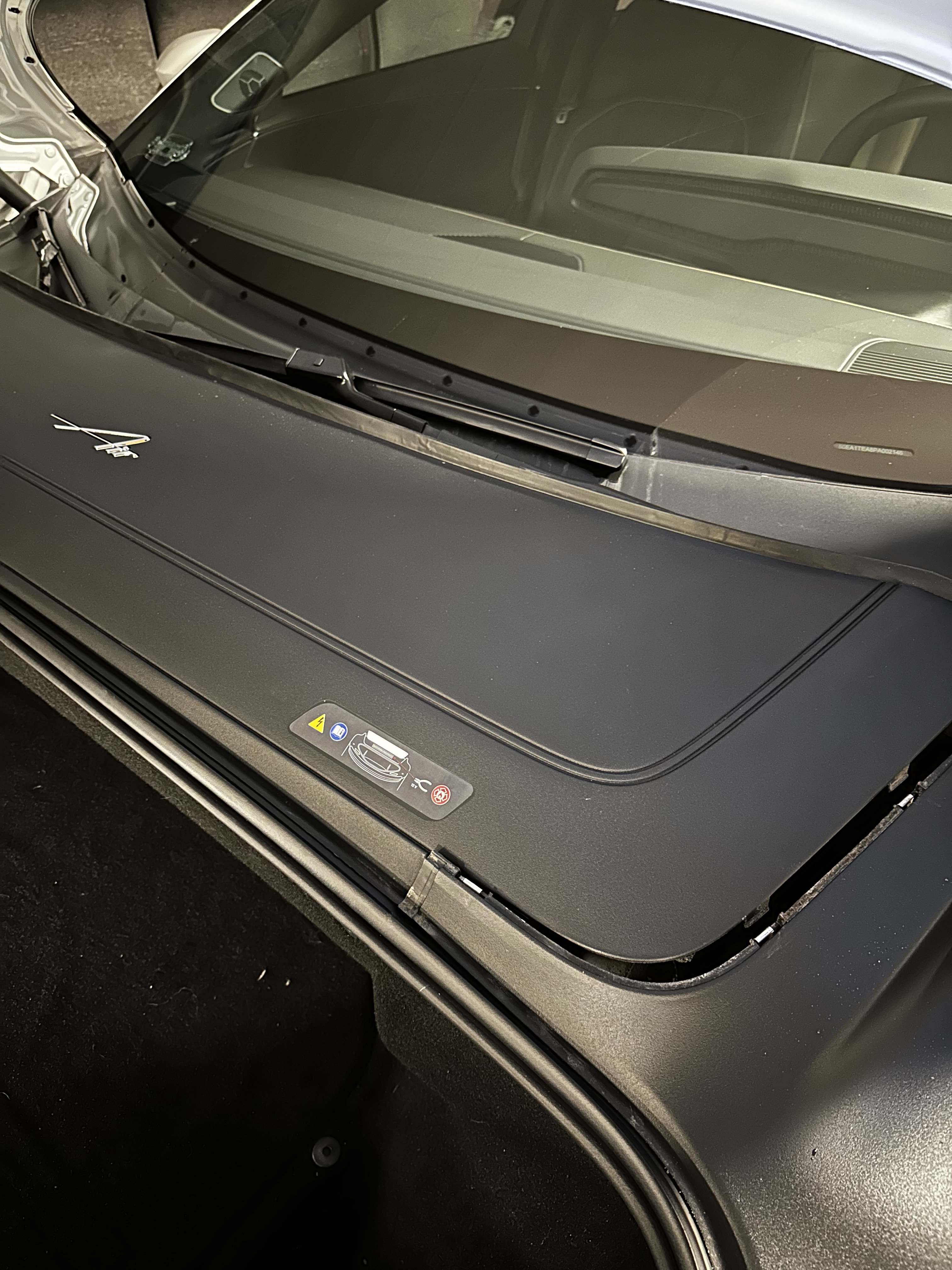 Under the frunk of the Lucid Air. Top plastic cover.